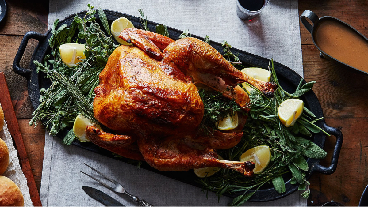 Rotisserie chicken served with rice, salad and sides