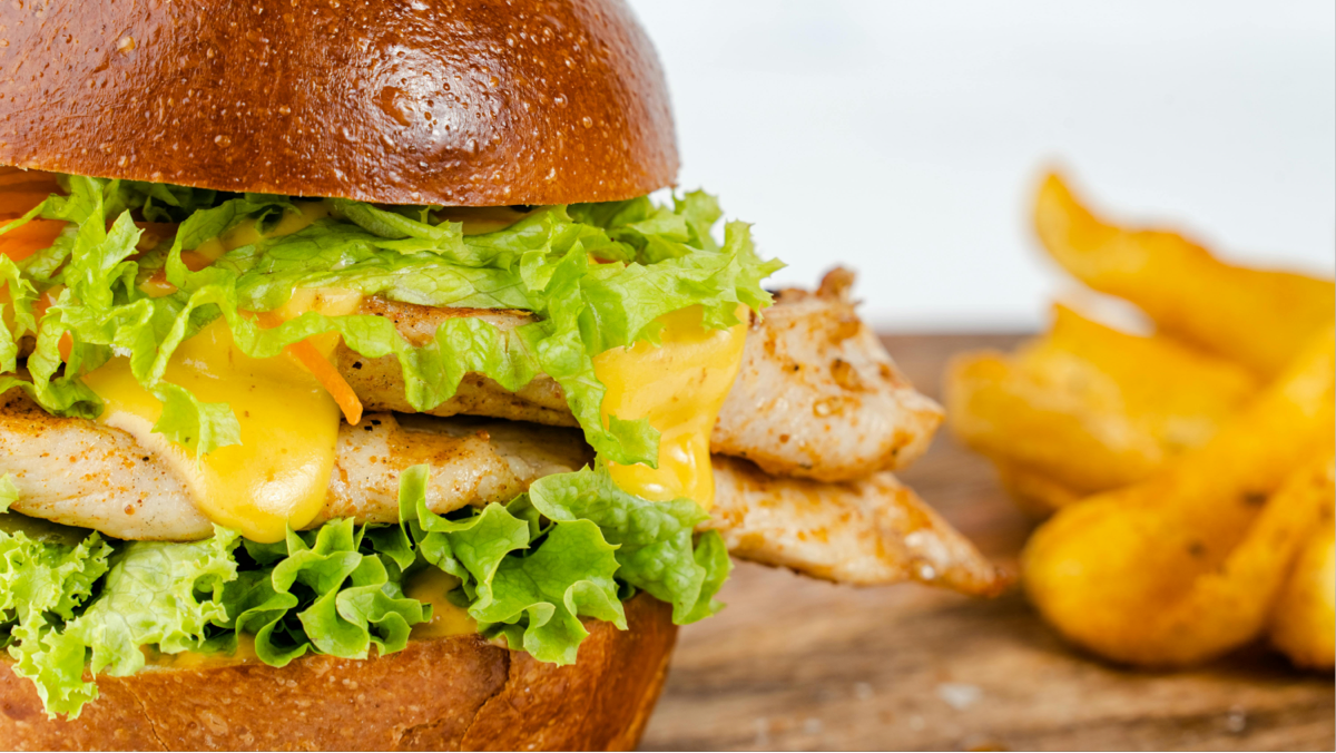 Chicken burger filled with freshly shredded rotisserie chicken, salad and sauce
