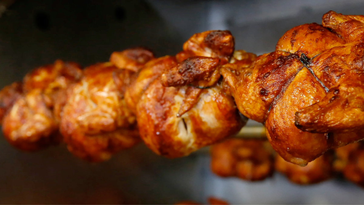 Whole chickens on rotisserie spit