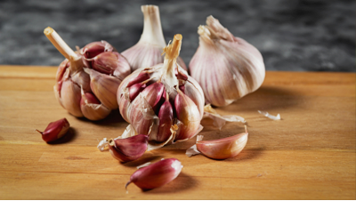 A spoon of thick garlic sauce beside grilled chicken and rice