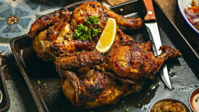 Rotisserie chicken set on a table ready for guests