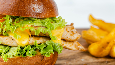 Chicken burger filled with freshly shredded rotisserie chicken, salad and sauce