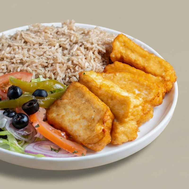 Slices of grilled halloumi on rice with salad