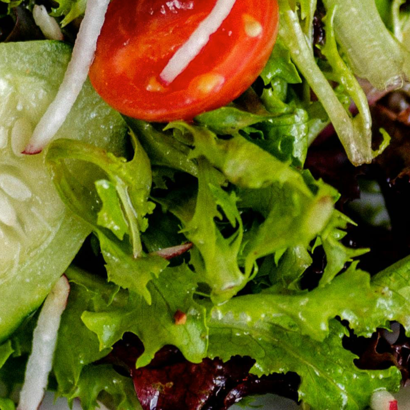 Mixed green salad with cucumber, tomato and herbs